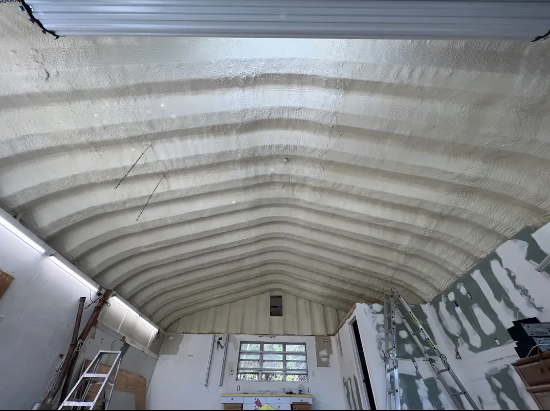 Spray polyurethane foam applied to the underside of a metal roof deck in Camden